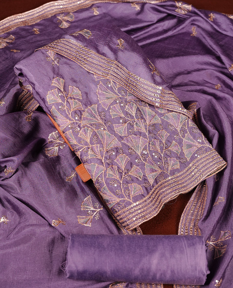 Lavender colour olive colour churidar material with subtle mirror and thread embroidery, finished with delicate border detailing and paired with a matching plain bottom and dupatta.