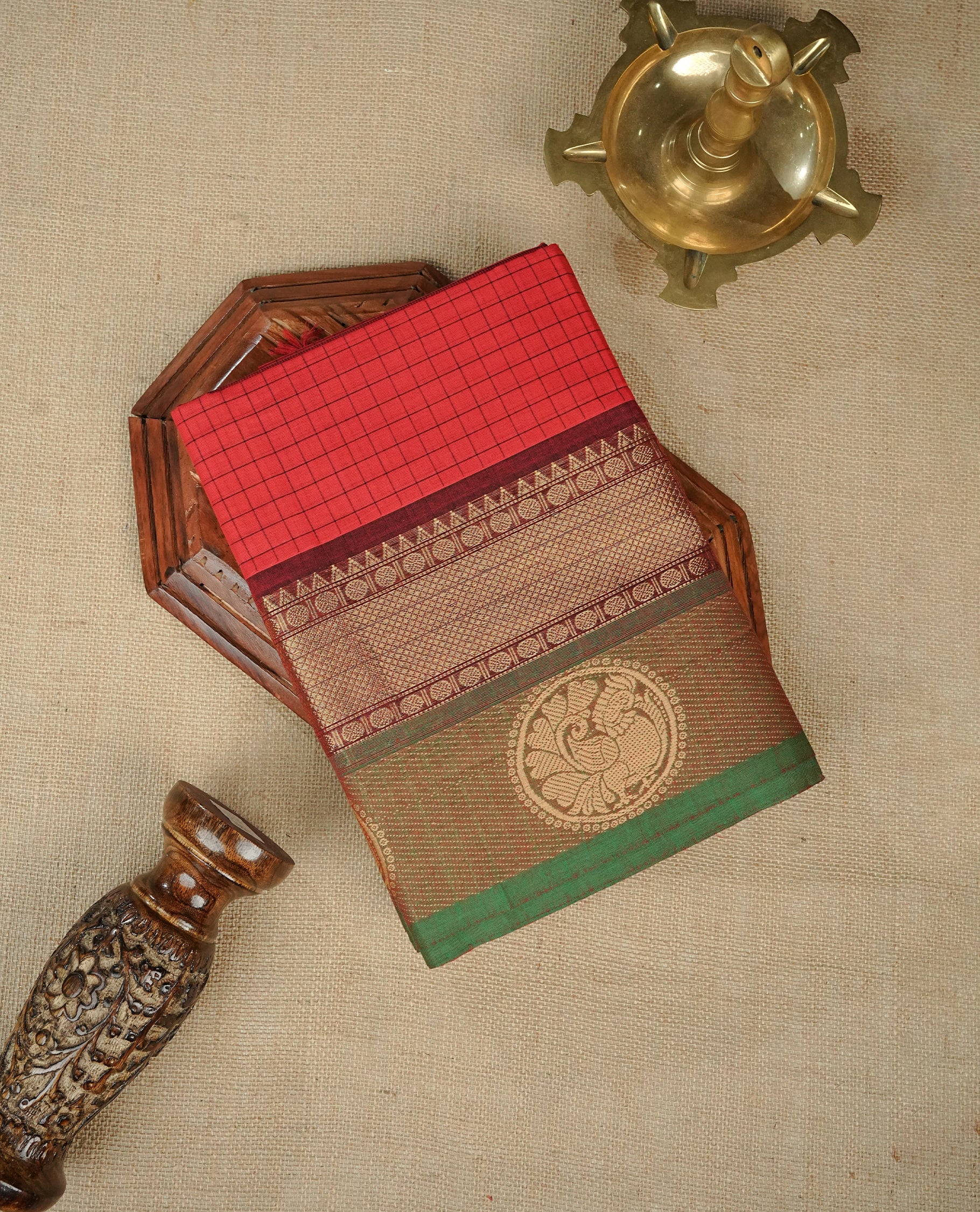 Red colour chettinad cotton saree featuring Check pattern on body, complemented by Contrast Maroon & Green Colour with gold zari border, comes with matching blouse piece.