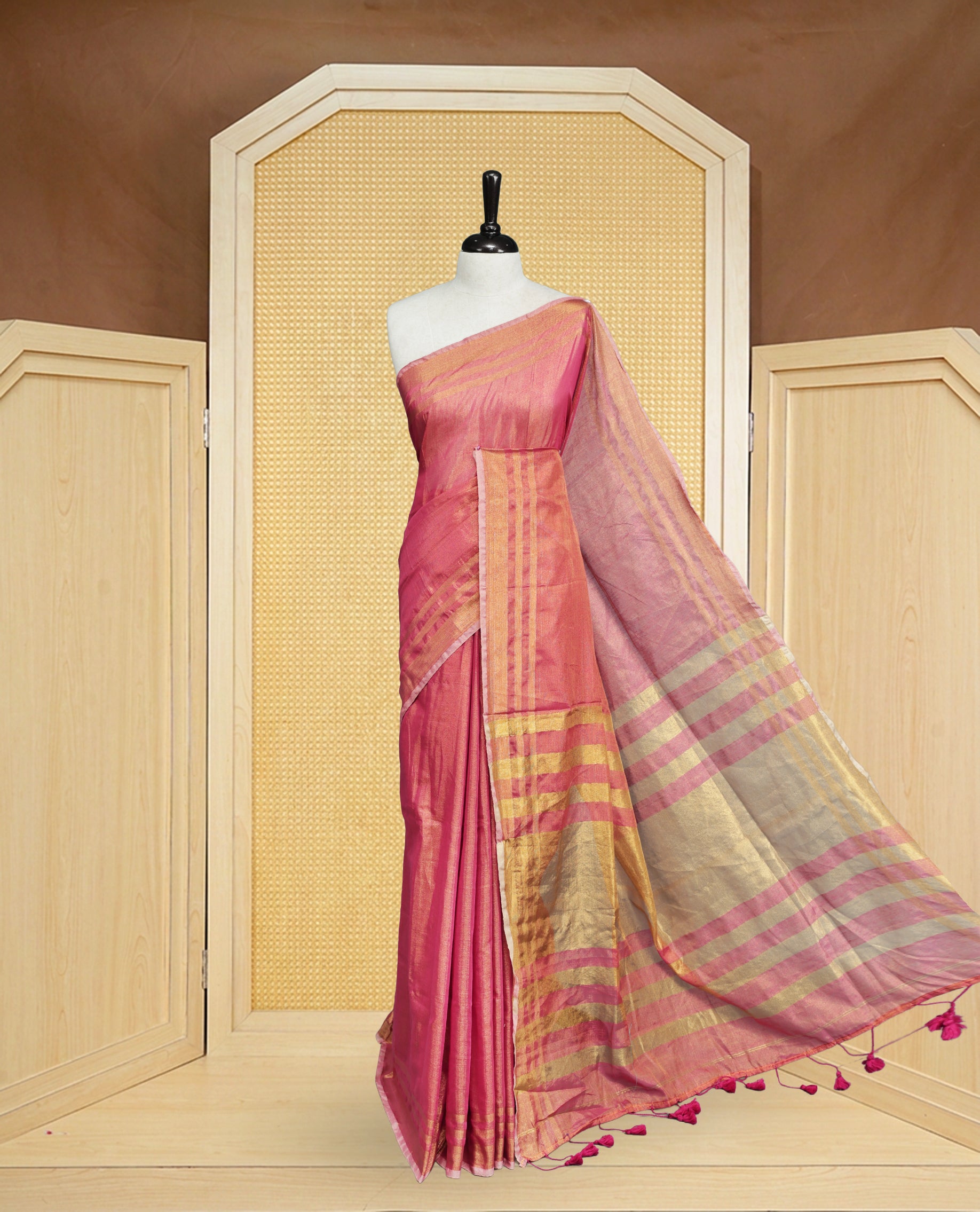 Pink colour Semi Tissue Silk saree featuring Elegant plain body, Enhanced with Gold tissue Border & Striped Pallu & beautiful Tassels for Elegant Prefect Look.