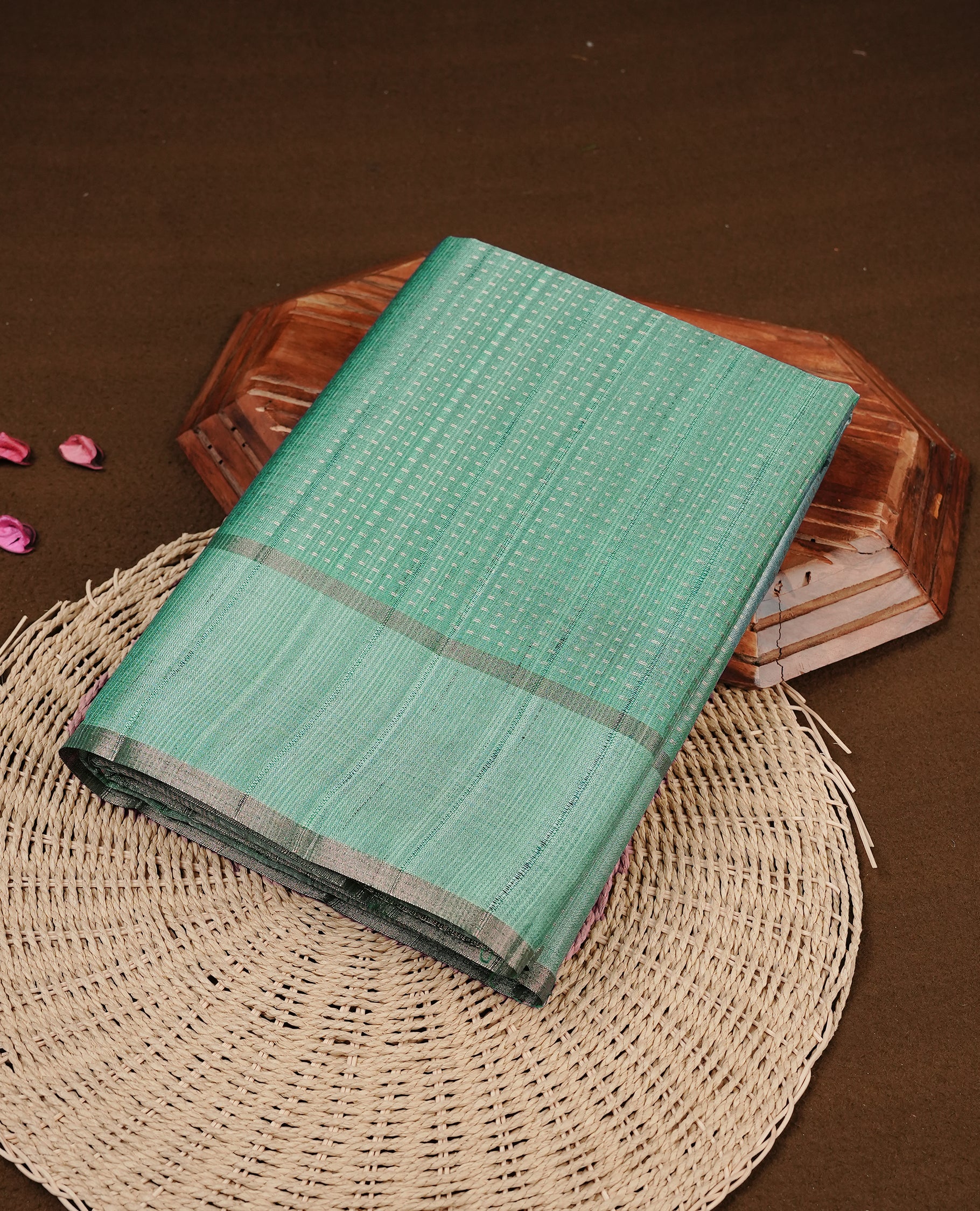 Aqua colour semi tussar silk saree featuring elegant gold zari dotted stripes across the body, enhanced with a rich zari woven border. Comes with a matching blouse piece.