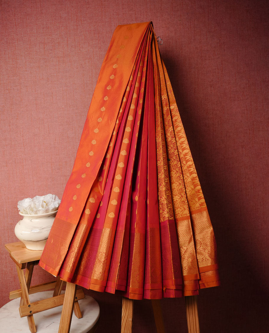 Orange colour soft silk saree featuring Gold zari motifs on body, complemented by self colour with traditional border, paired with matching blouse piece.