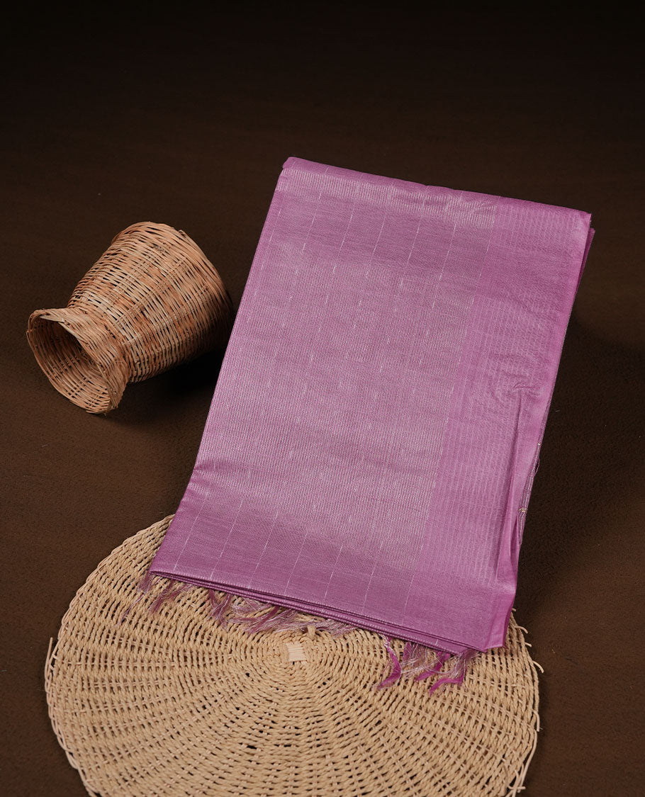 Pink colour semi jute saree highlighting gold zari striped body, without border and paired with matching blouse.
