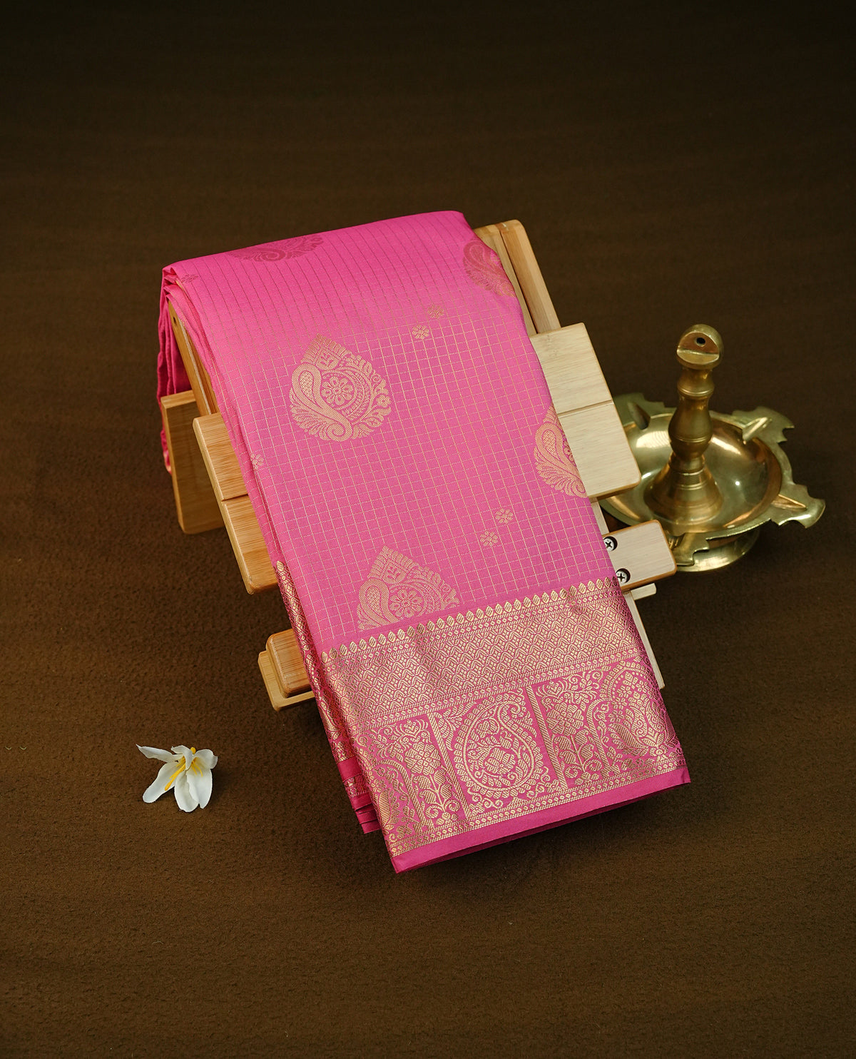Magenta colour semi wedding saree featuring gold zari check with motifs on body complemented by Self colour with traditional border, comes with matching blouse piece.