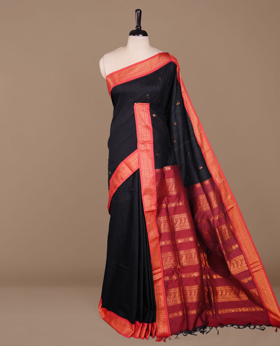 Black colour kalyani cotton saree featuring antique zari motifs on body, complemented by red colour with Antique zari border, paired with matching blouse piece.