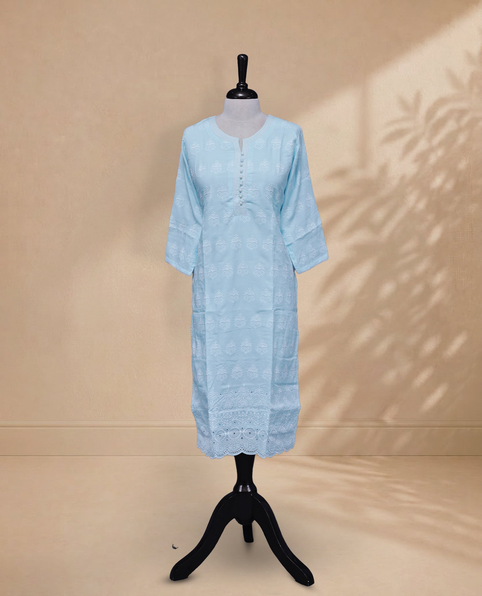 Blue Colour kurti featuring a classic U-shaped Thread Pattern neckline, Beads & Light Blue Floral Prints on the body, and sleeves.