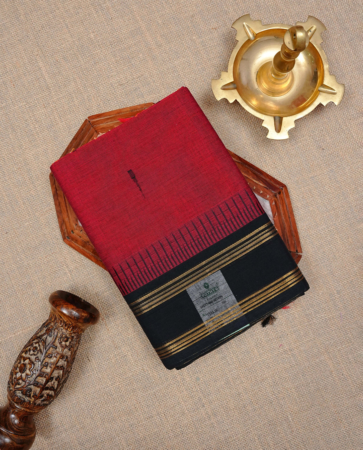 Brick Red Colour Chettinad cotton saree featuring Pain body , complemented by a classic black contrast border adorned with elegant gold zari stripes and a matching striped pallu, paired with a matching blouse piece.