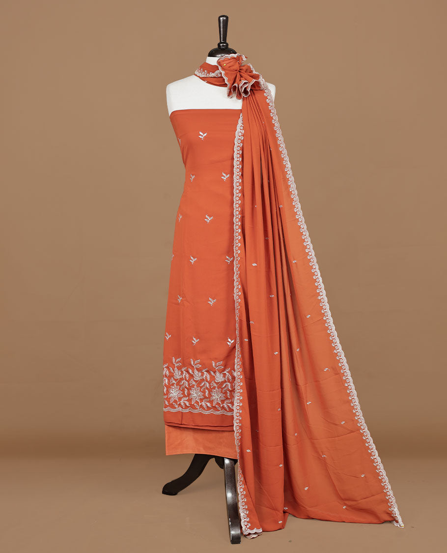 Orange colour churidhar material featuring gold thread floral pattern on body, paired with matching bottom & dupatta.