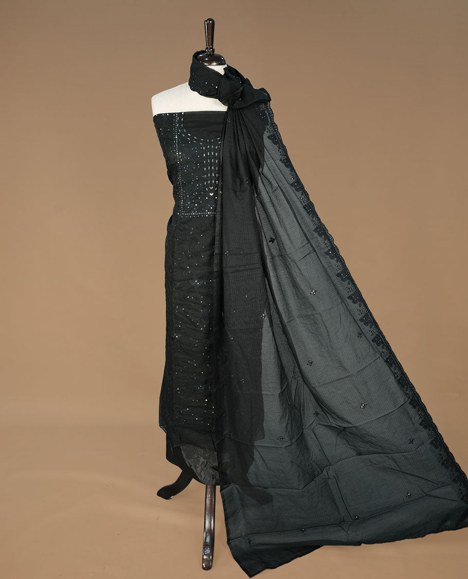 Black colour churidhar material featuring self colour thread and sequins work on body, paired with matching bottom and Dupatta.