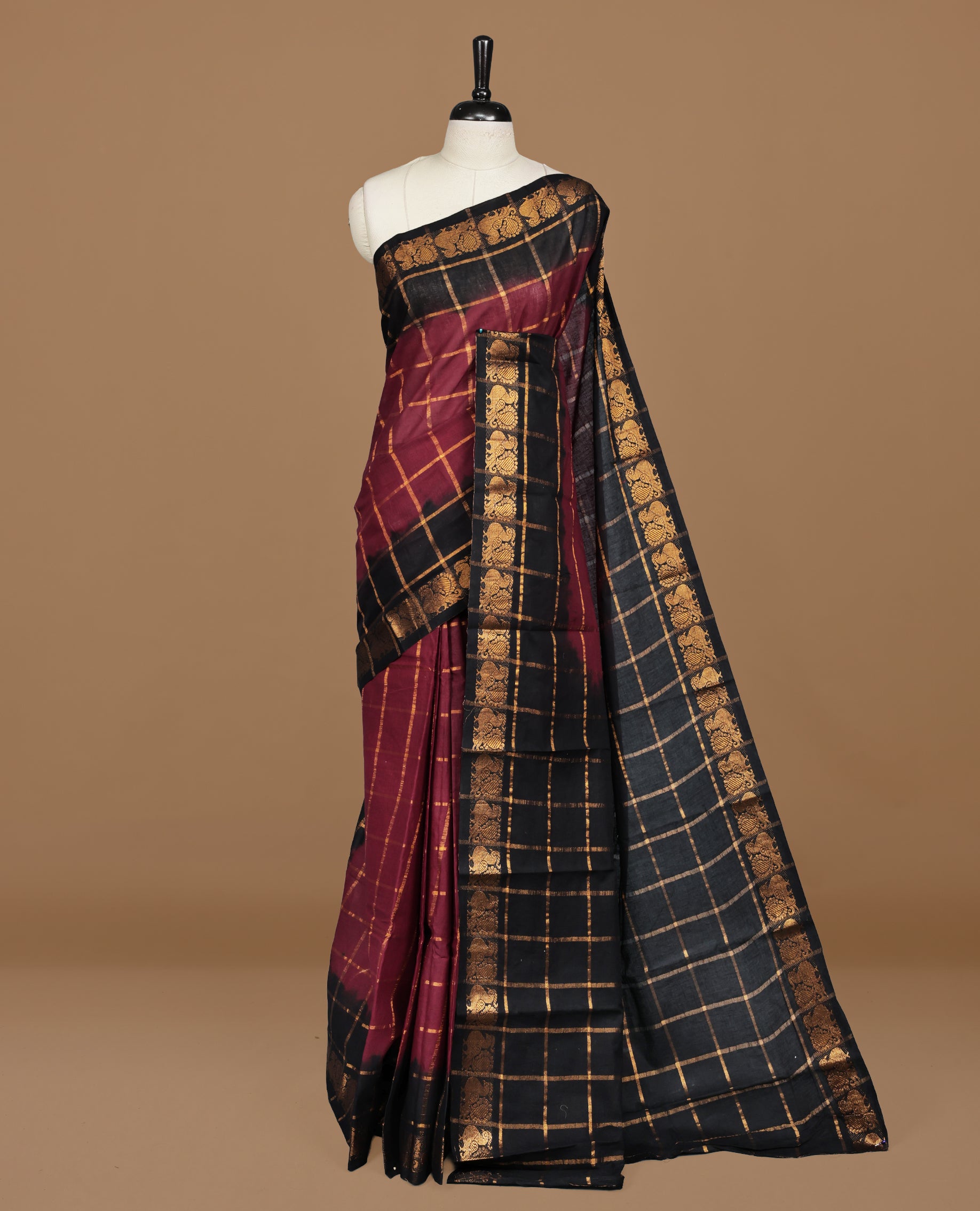 Maroon colour Sungudi cotton saree featuring Gold zari Check pattern on body, Gold zari Peacock design on Dyed Black colour design border, paired with matching blouse piece.
