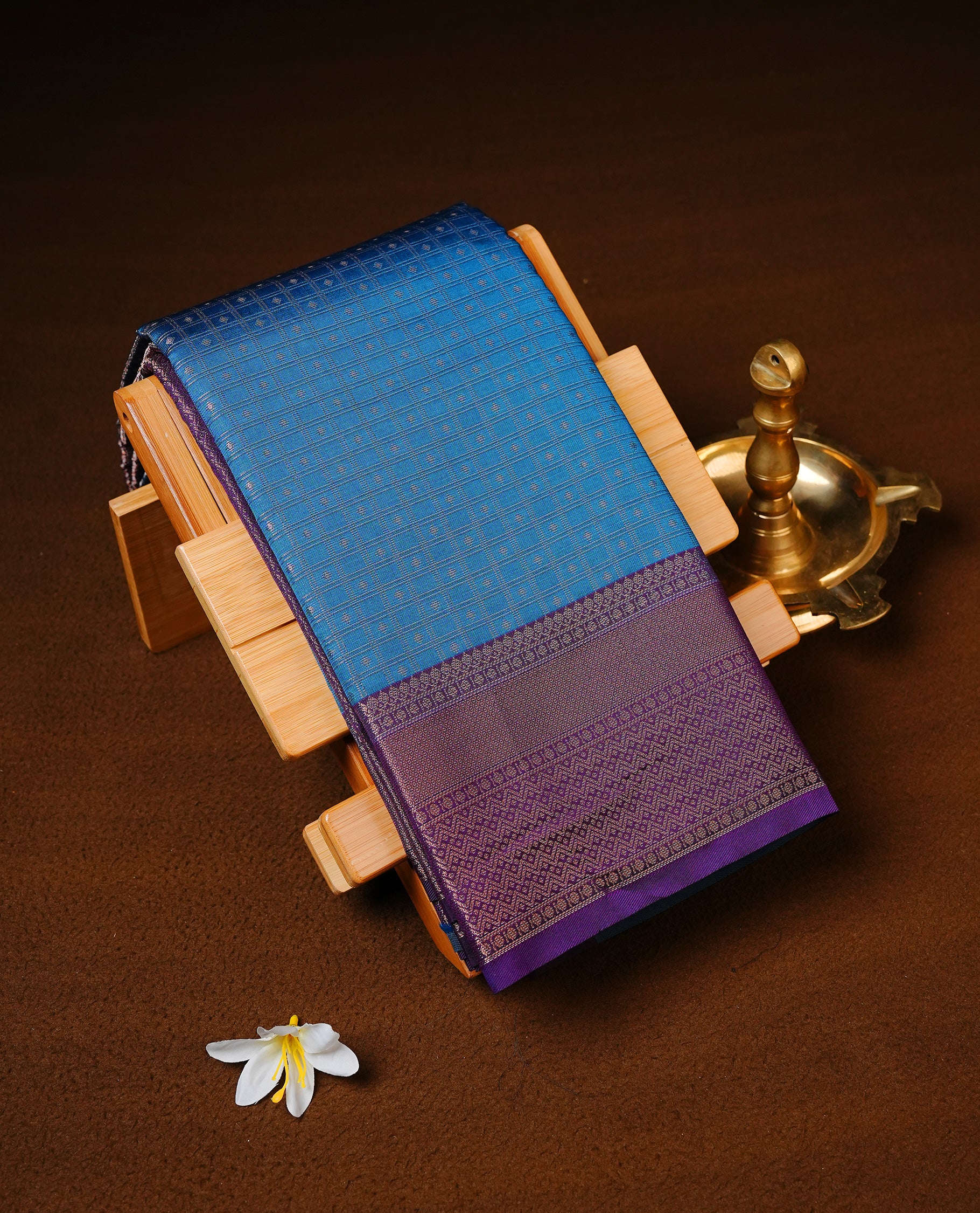 Teal Colour Semi wedding silk saree Featuring Silver Zari Check across Body, Complemented by Contrast Purple Colour With traditional Border, paired with matching blouse Piece.