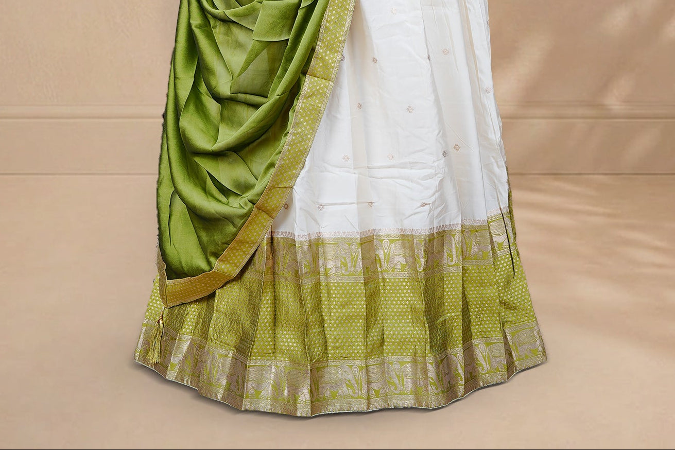 Cream colour Half saree featuring Gold zari buttas on skirt with Zari border on contrast Green colour border, Unstitched Blouse and matching dupatta.