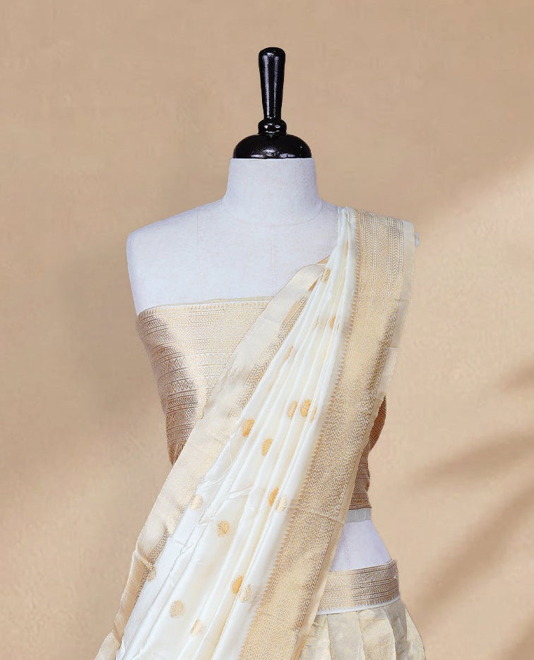 Golden colour Half saree featuring Plain skirt with Traditional zari on self colour border, Unstitched Blouse and matching dupatta.
