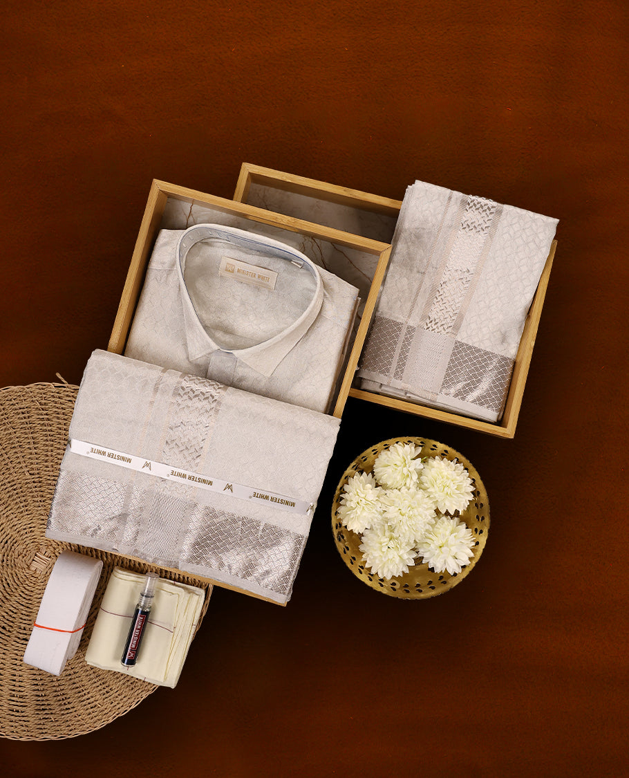White silver colour MINISTER WHITE jacquard shirt with an all over textured weave, paired with a matching silver zari bordered dhoti featuring intricate geometric patterns, perfect for a refined traditional look.