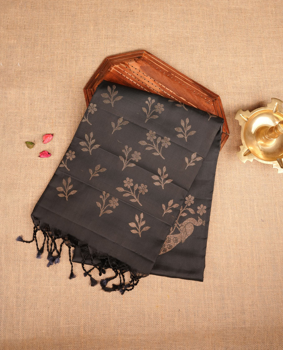 Black colour soft silk saree featuring gold zari peacock motifs on body, complemented by self colour with gold zari border, peacock print on pallu, paired with matching blouse piece.