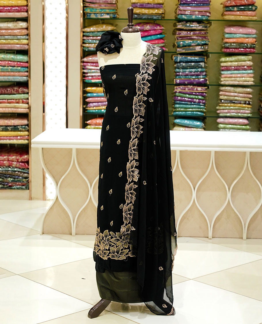 Black colour georgette salwar set featuring gold zari buttas on body, floral embroidery and scalp work on dupatta, paired with matching bottom.