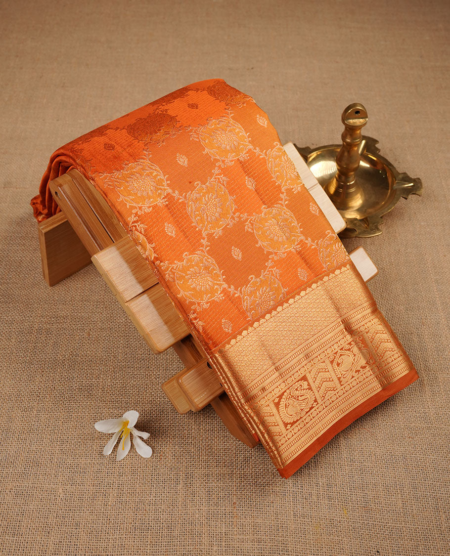 Golden mustard colour kancheepuram silk saree featuring floral meena zari jacquard on body with traditional border, paired with matching blouse piece.