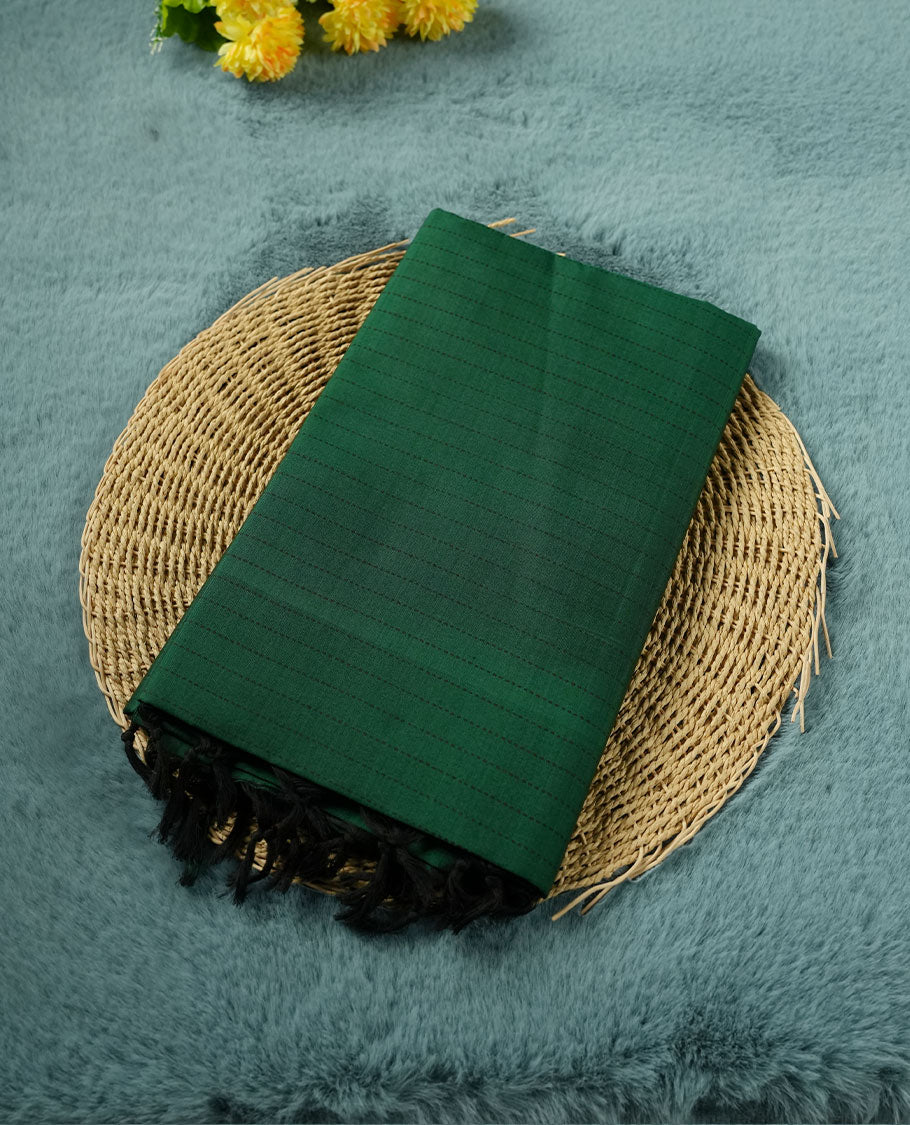 Dark Green colour poly cotton saree with black vertical dotted line pattern on the body, paired with a matching pallu featuring black zigzag geometric border, and a coordinated all‑over black stylised fleur‑de‑lis printed blouse piece.
