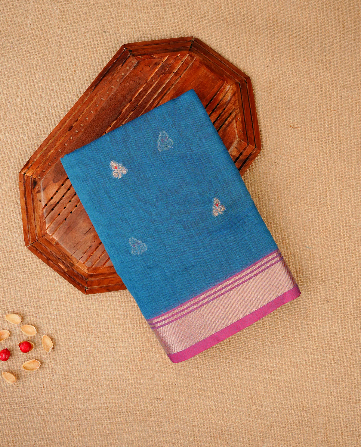 Teal blue colour Maheshwari cotton saree, gold zari floral motifs on body, complement light magenta colour gold zari border comes with matching blouse.