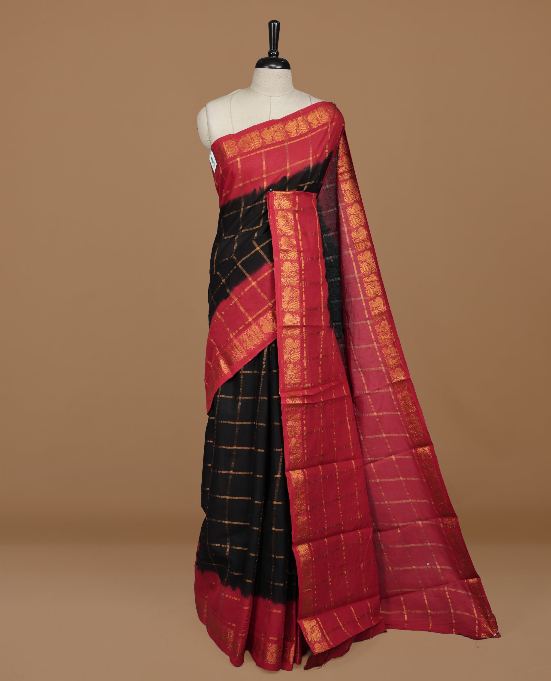 Black colour Sungudi cotton saree featuring Gold zari Check pattern on body, Gold zari Peacock design on Dyed Red colour design border, paired with matching blouse piece.