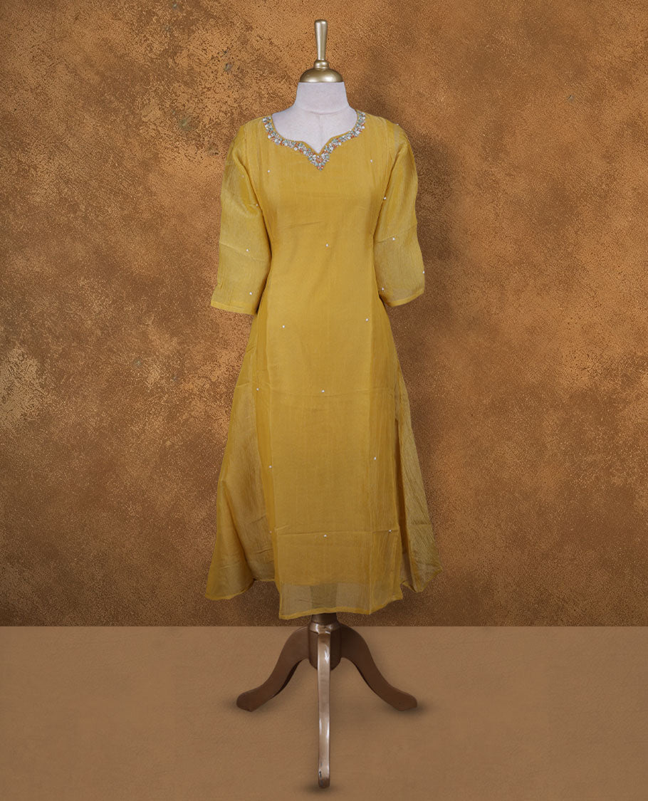 Mustard colour kurti styled with agold colour thread & beats floral thread pattern Round neckline, knee length design, styled with a Round neckline and a sleeve .