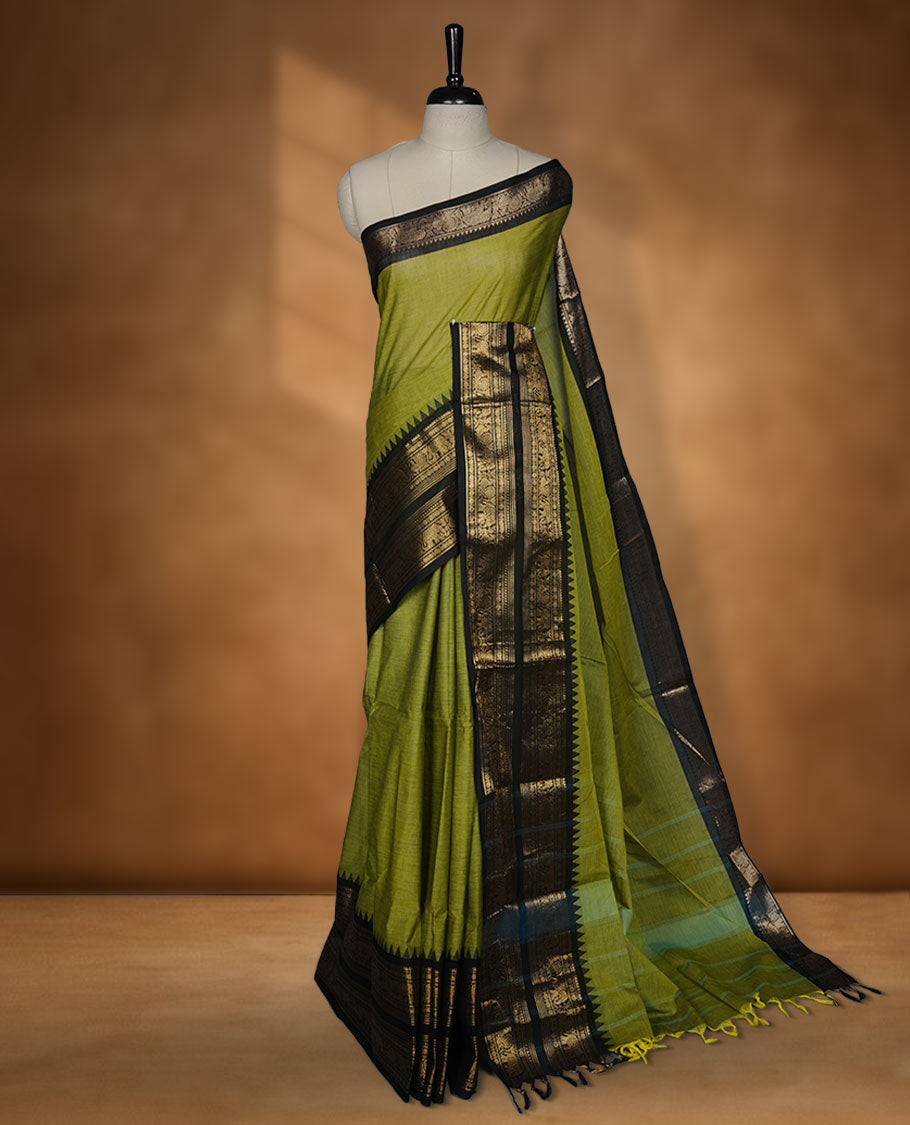 Lemon green colour chettinad cotton saree featuring plain body, contrast black colour with traditional gold zari border without blouse.
