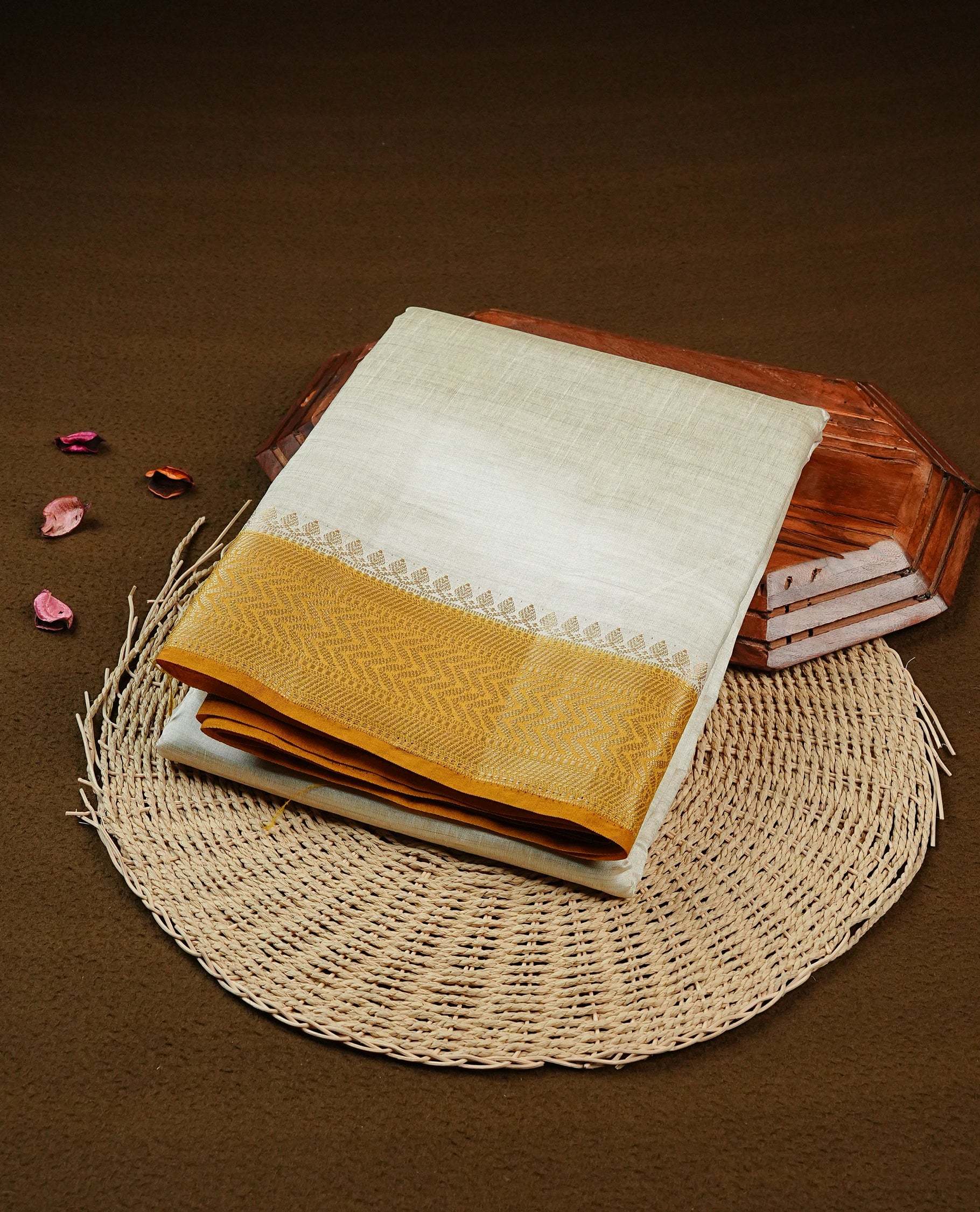 Off white Tussar saree featuring Elegant body, complemented by contrast Mustard Colour with Gold zari border, comes with matching blouse piece.
