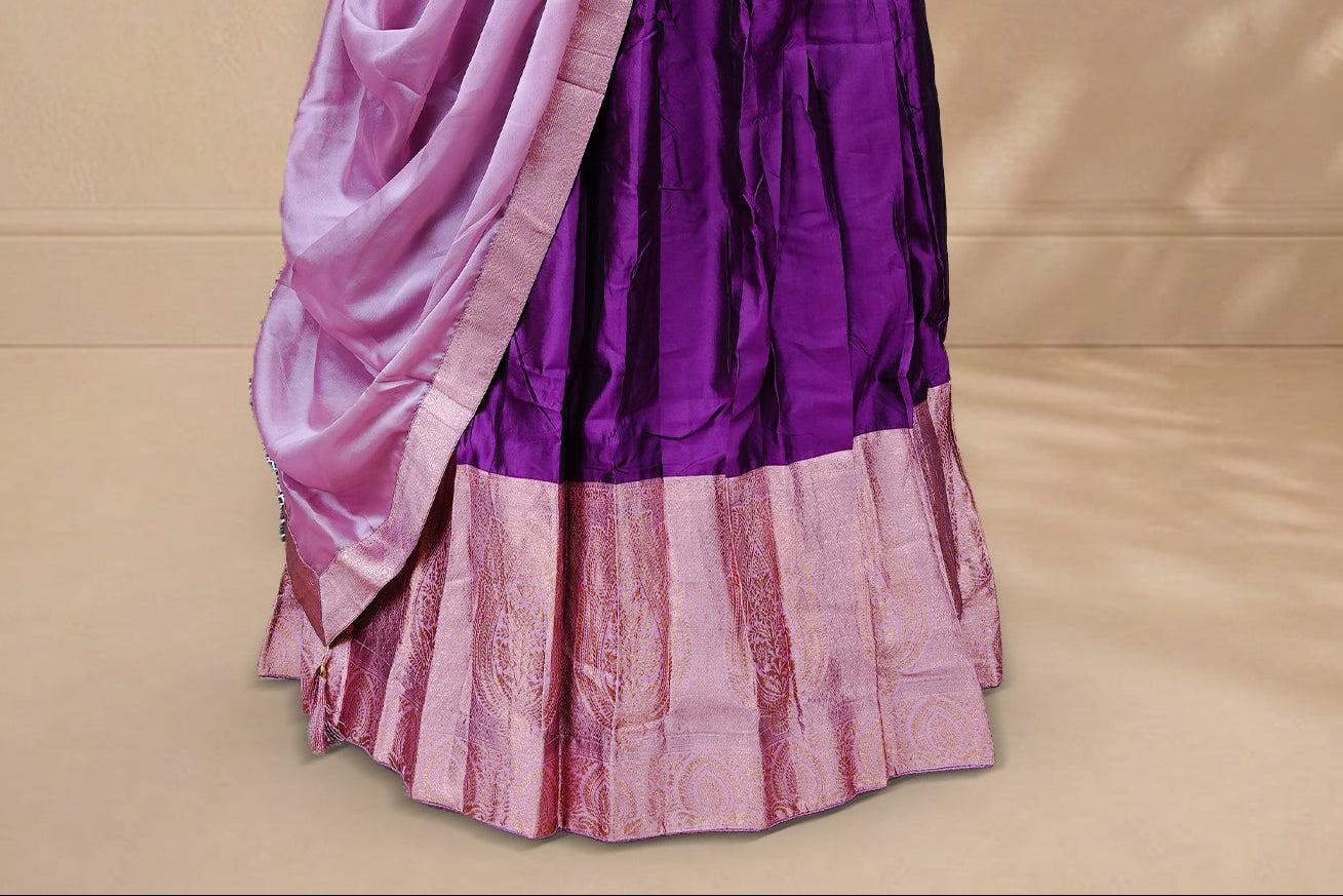 Purple colour Half saree featuring Plain skirt with Zari border on contrast Pink colour border, Unstitched Blouse and matching dupatta.