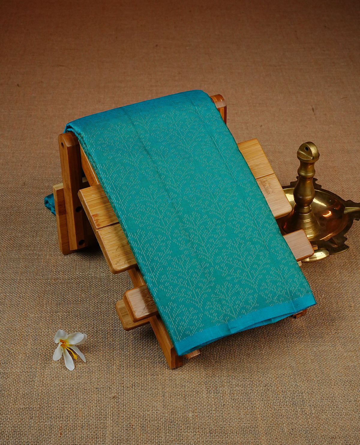 Aqua Blue Colour soft silk saree featuring elegant self woven leaf motifs across the body, complemented by a richly woven self design pallu, paired with a matching plain blouse piece.