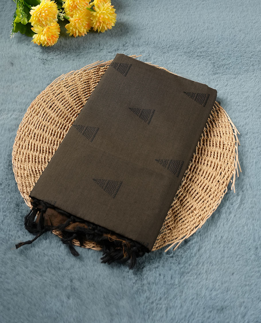 Dark olive brown poly cotton saree with black temple motifs on the body, paired with a matching pallu with black woven traditional border, and a coordinated all‑over geometric printed blouse piece.