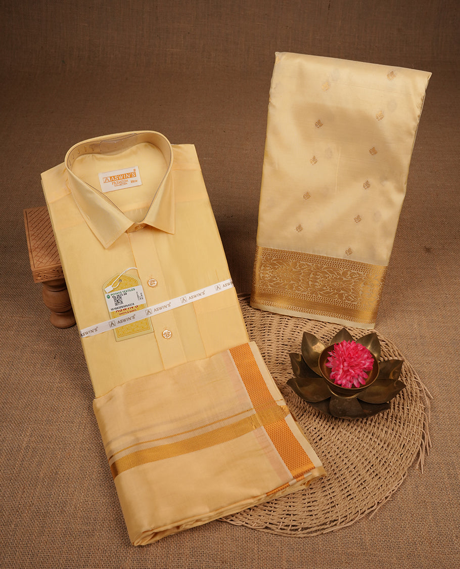 Champ colour shirt and dhoti with gold colour border, paired with matching colour silk saree featuring gold zari buttas and traditional border paired with matching blouse piece.