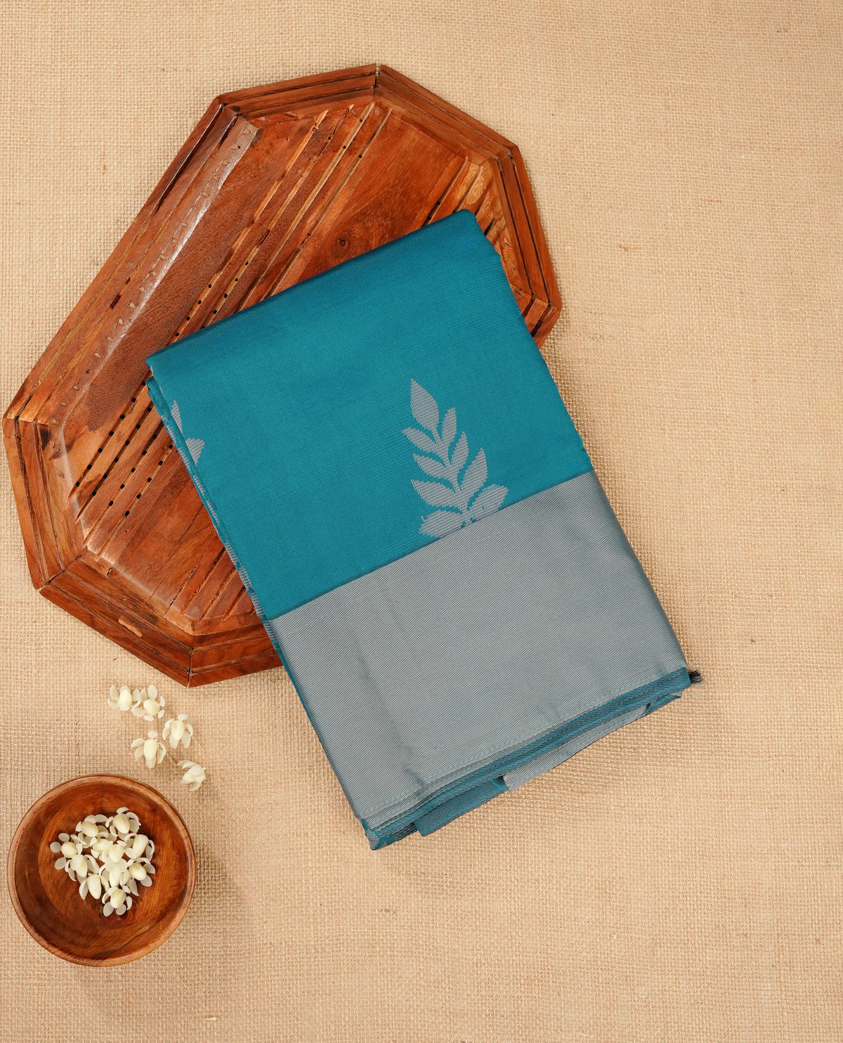 Teal blue colour silk cotton saree featuring ash blue colour thread motifs on body thread detiled contrast borders & pallu,comes with matching blouse piece