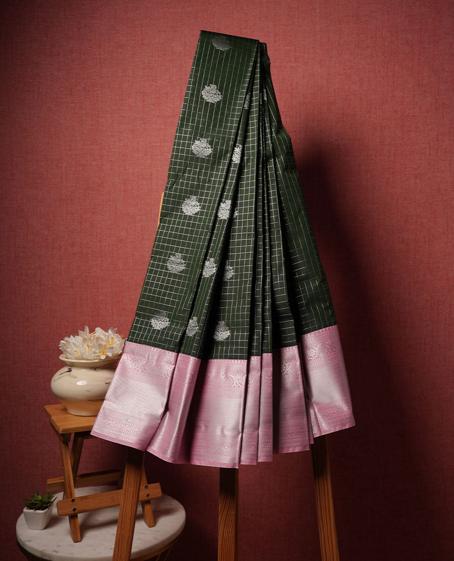 Black colour semi silk saree highlighting silver zari check pattern and motifs across body, featuring contrast baby pink colour border with silver zari pattern, comes with matching blouse .