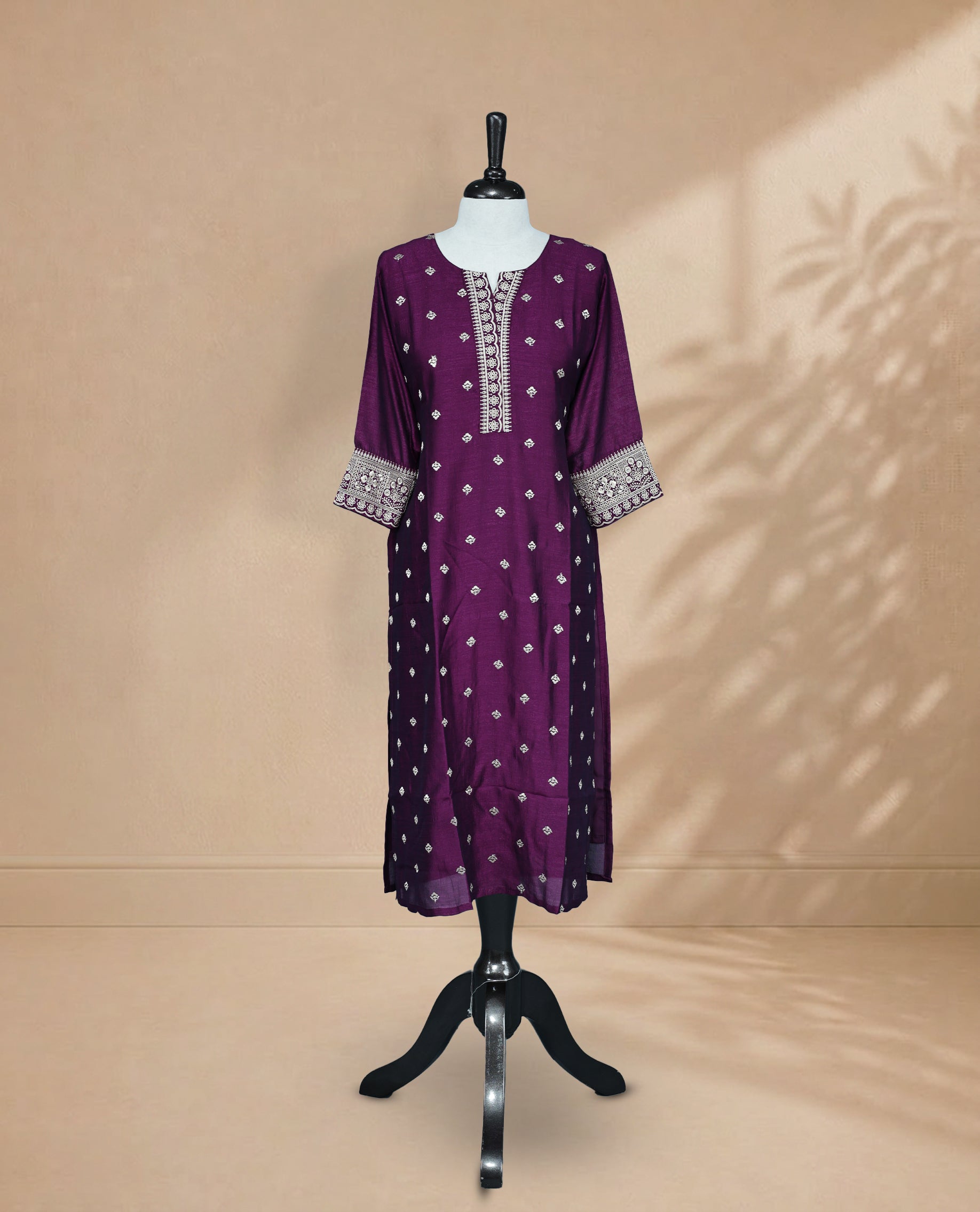 Dark Plum Kurti featuring threadwork across the body, a U-shaped neckline adorned with threadwork, and 3/4 sleeves with matching threadwork.