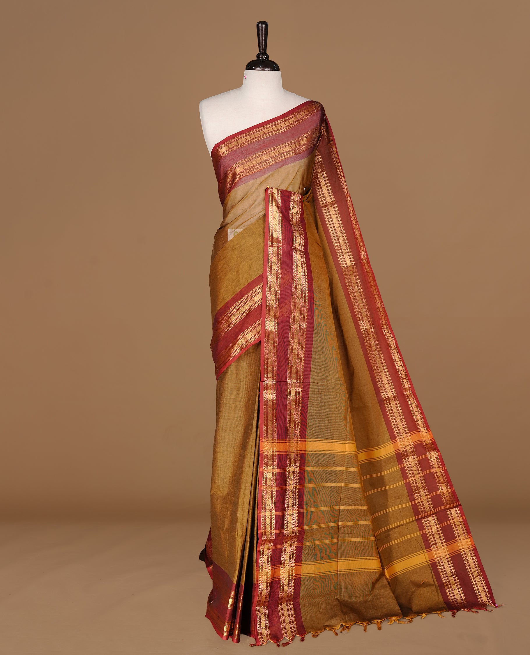 Dark olive colour Chettinad cotton saree featuring Elegant plain body, complemented by contrast Maroon colour with gold zari border, paired with matching blouse piece.