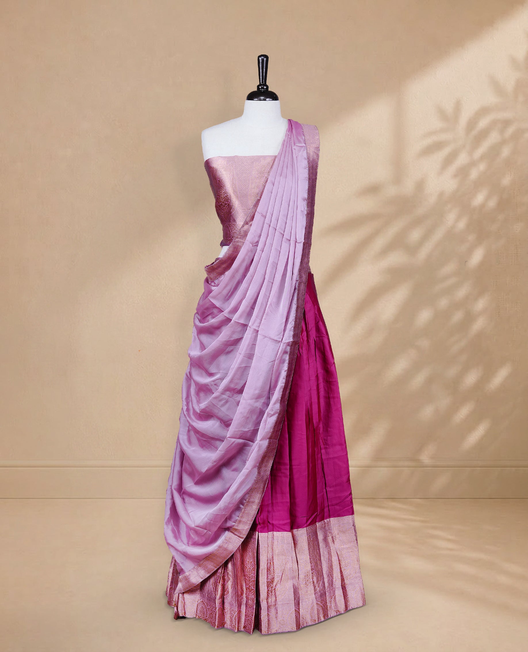 Magenta colour Half saree featuring Plain skirt with Zari border on contrast Light pink colour border, Unstitched Blouse and matching dupatta.