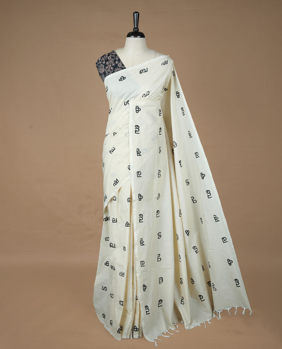 Cream colour poly cotton saree featuring Malayalam letter printed body, without border, comes with Double blouse option and running blouse piece