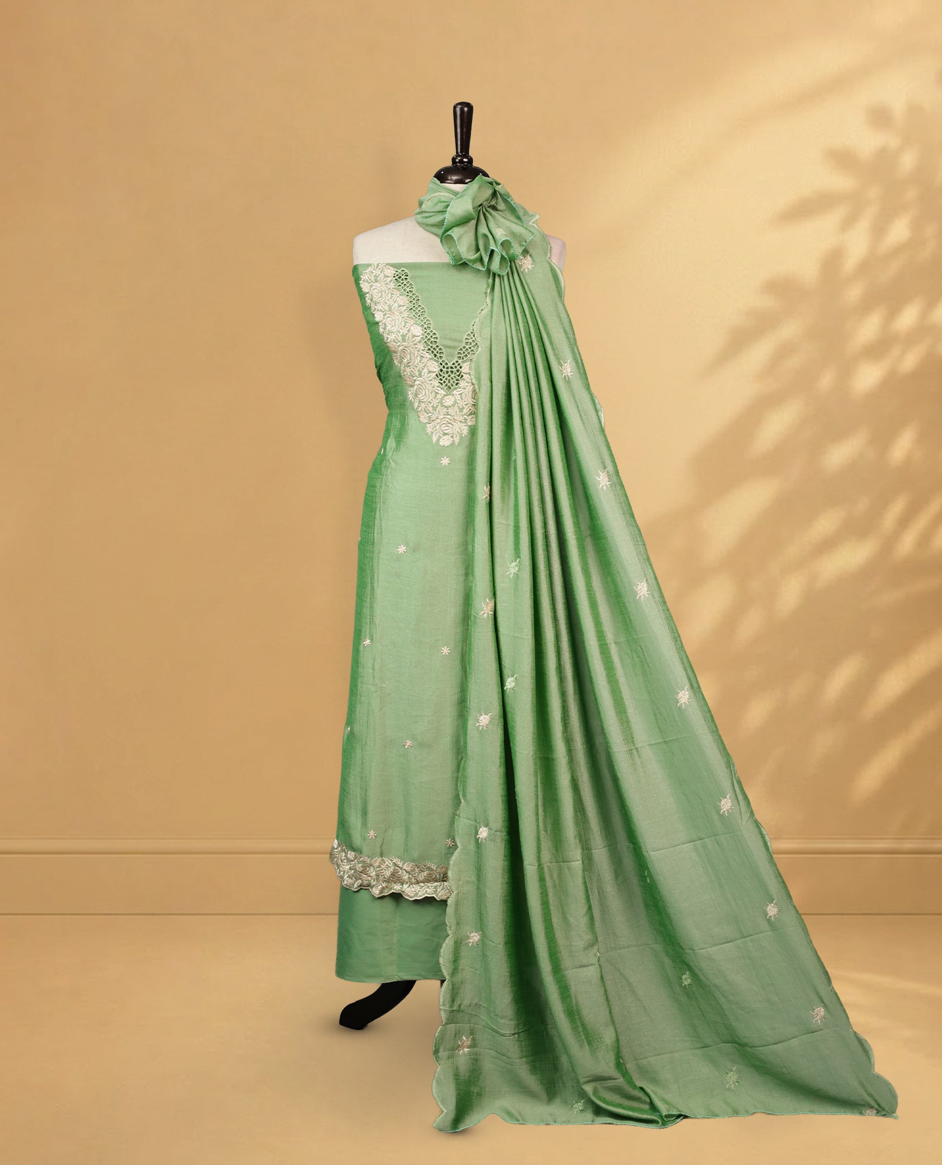 Pale green colour Salwar Material Featuring Cream colour Thread pattern on Neckline & Small Buttas, paired with matching bottom & Same Colour Dupatta.