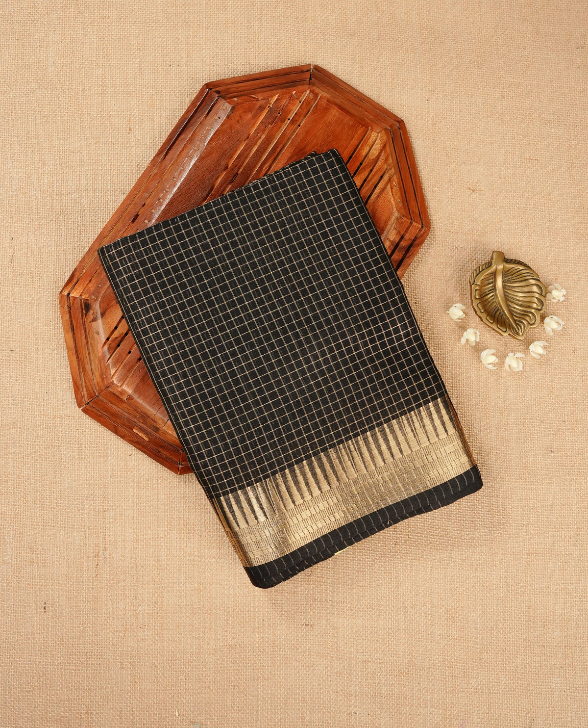 Black colour Maheshwari cotton saree, gold zari small checks on body, complement self colour gold zari temple design border comes with matching blouse.