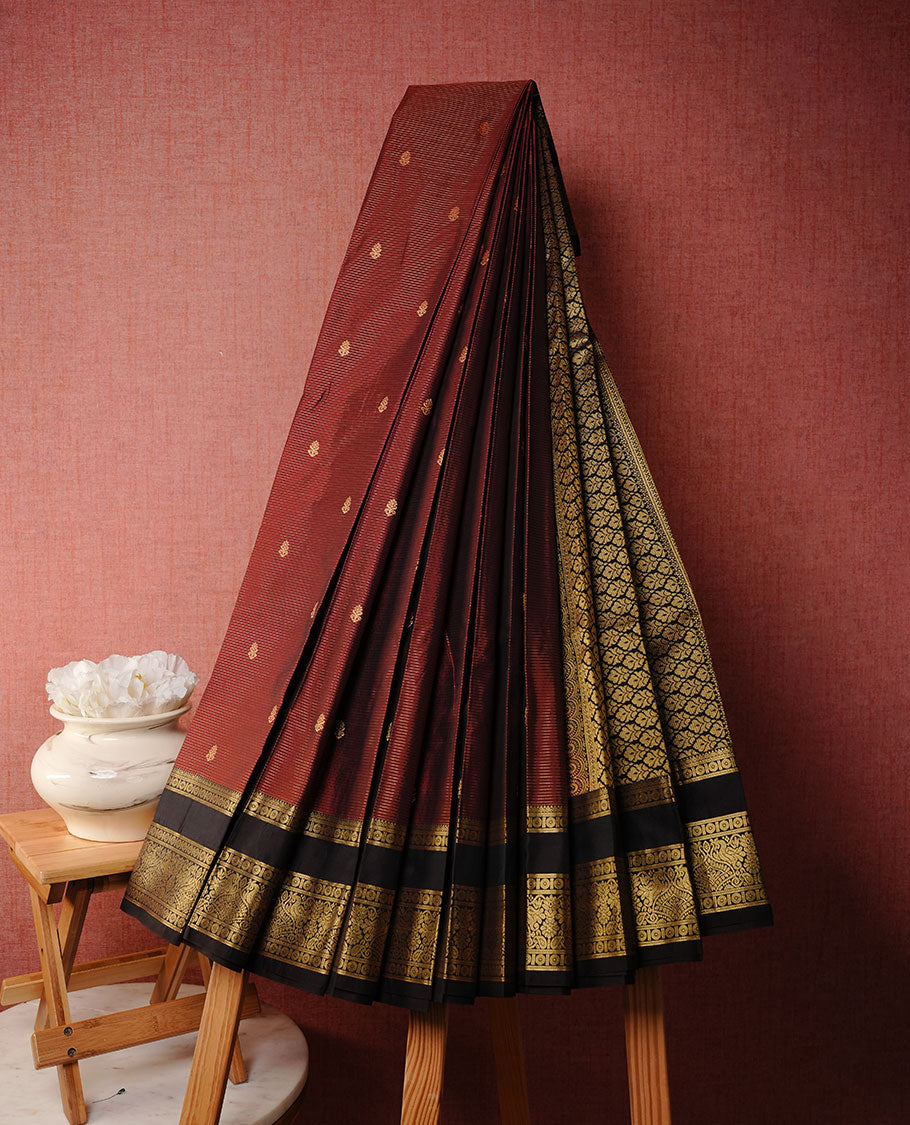 Maroon colour soft silk saree featuring gold zari check & motifs on body, complemented by contrast dark chocolate colour with zari border, paired with matching blouse piece.
