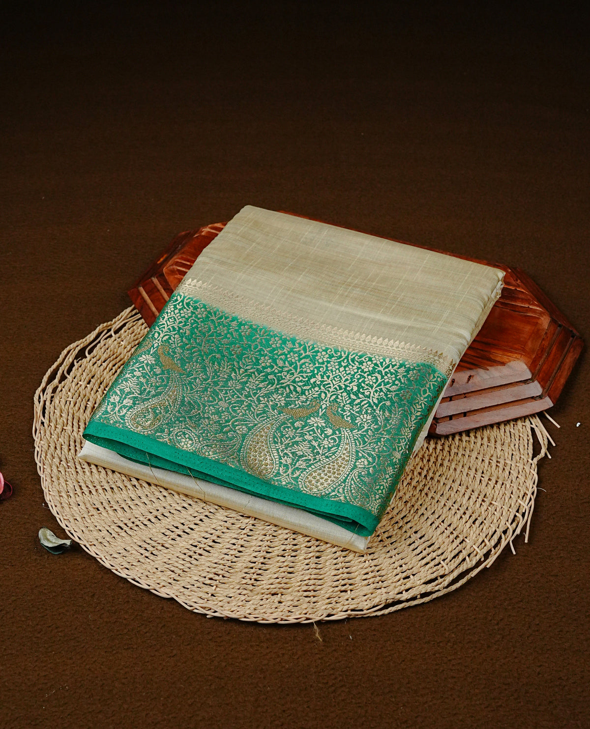 Light gold tussar saree featuring Elegant plain body, complemented by contrast Green colour with Gold zari Floral kodi with Peacock Pattern border, comes with matching blouse piece.