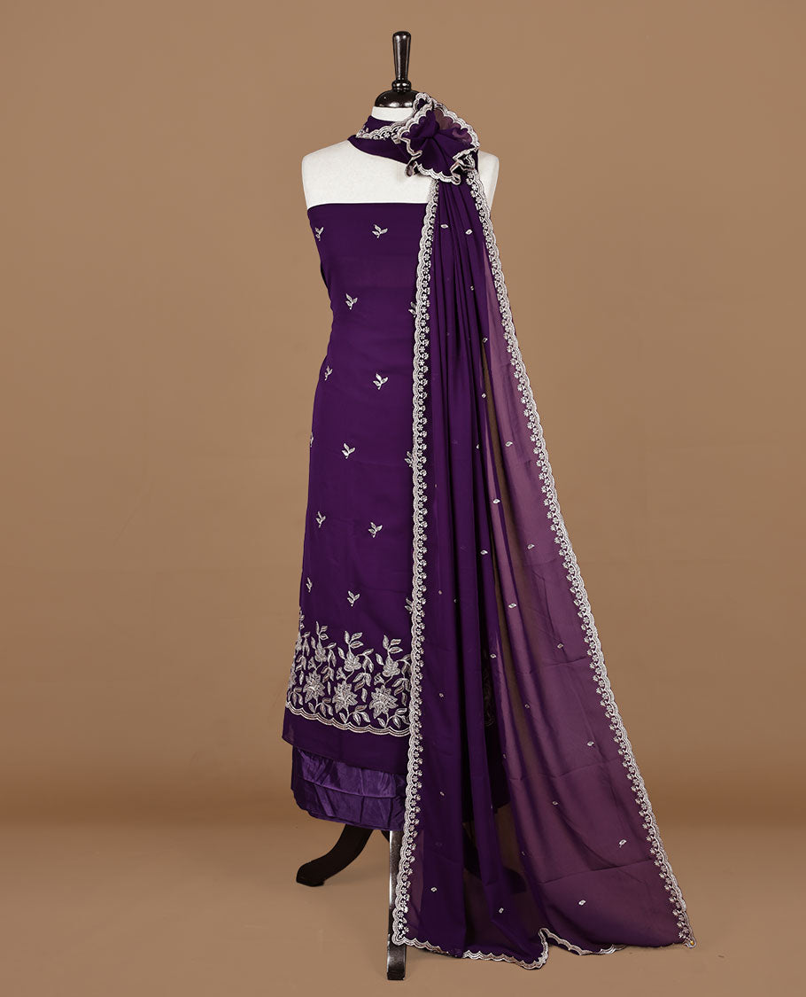 Purple colour churidhar material featuring gold thread floral pattern on body, paired with matching bottom & dupatta.