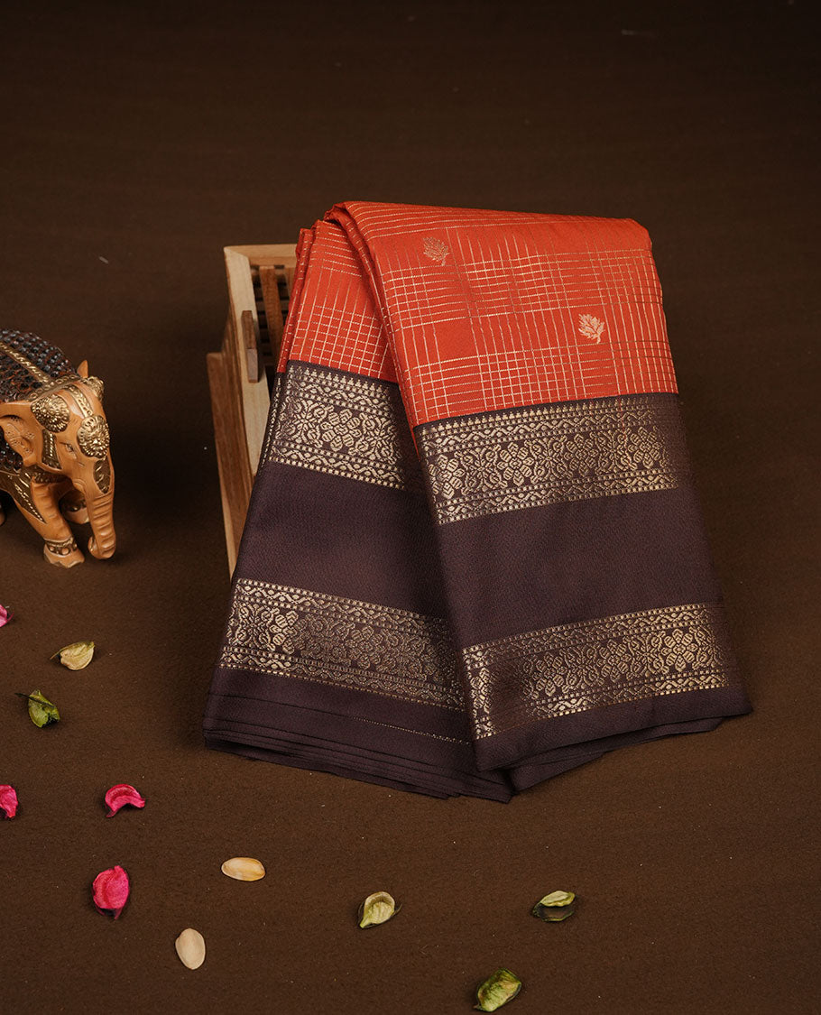 Dark Rust orange colour semi silk saree featuring gold zari checks and small motifs on body highlighting contrast dark chocolate border , paired with matching blouse