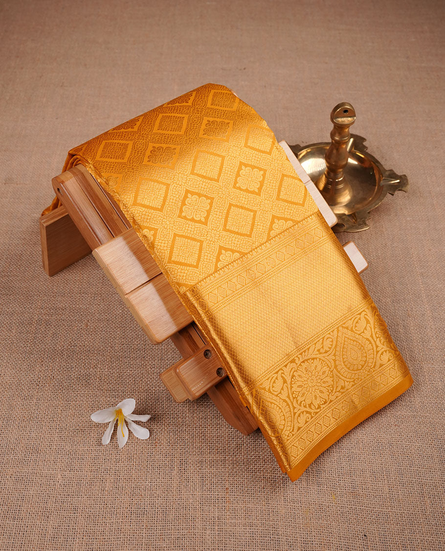 Golden mustard colour kancheepuram silk saree featuring Floral and diamond zari jacquard on body with traditional zari border, paired with matching blouse piece.