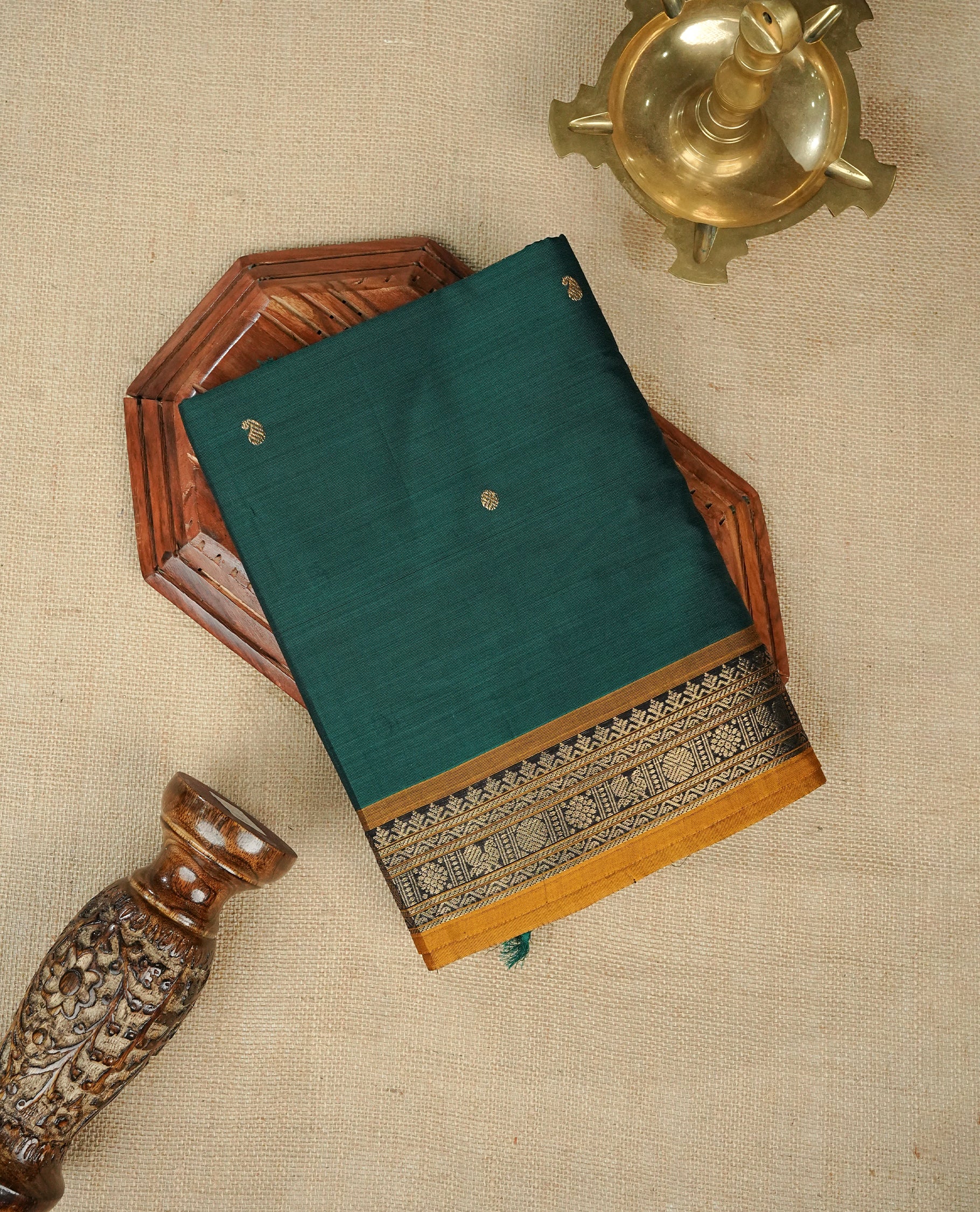Green colour chettinad cotton saree featuring Gold zari motifs on body, complemented by contrast mustard yellow colour with Gold zari border, comes with matching blouse piece.