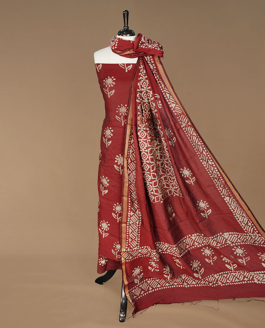 Maroon colour churidhar material featuring cream colour floral print on body, paired with matching bottom and Dupatta.