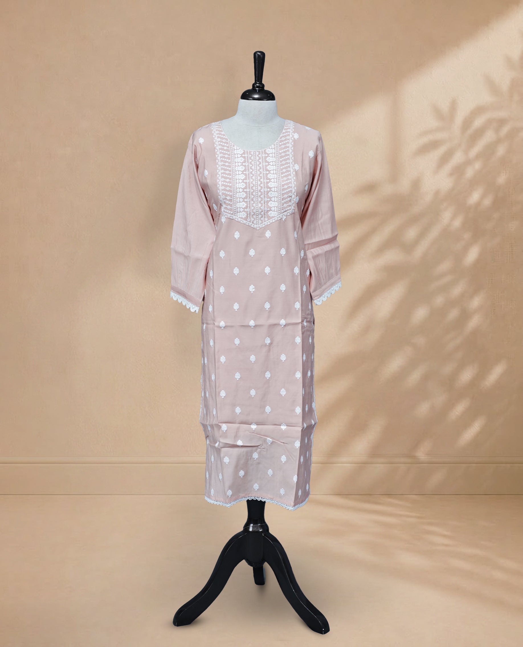 Peach Colour kurti featuring a classic U-shaped neckline, White Floral Embroidery Work on the body, and sleeves.