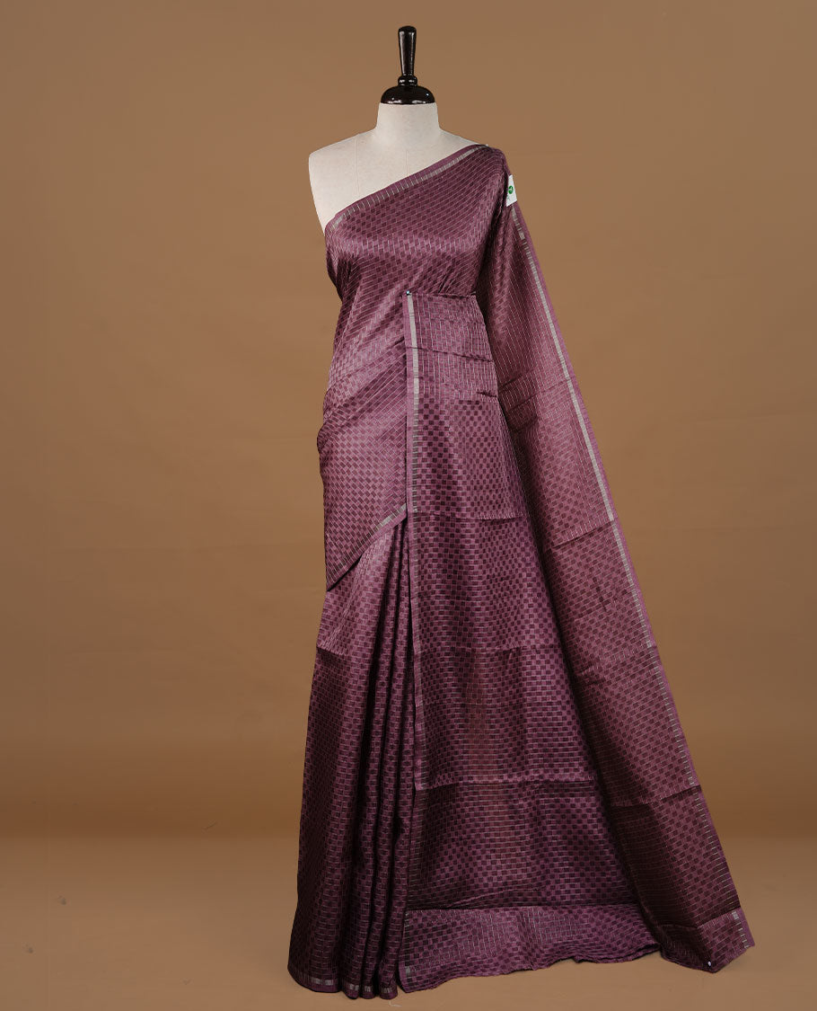 Onion colour Semi Tussar saree featuring an elegant zari fancy check pattern on the body, highlighted with a small border for a refined look. Comes without a blouse piece.