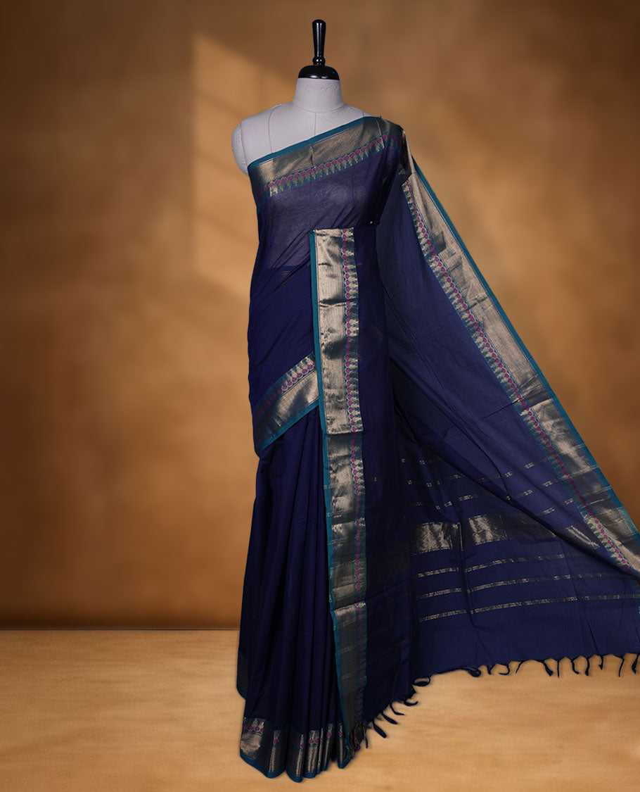 Navy Blue colour chettinad cotton saree featuring Elegant plain body, contrast green colour border with gold zari border, pallu and paired with matching blouse.