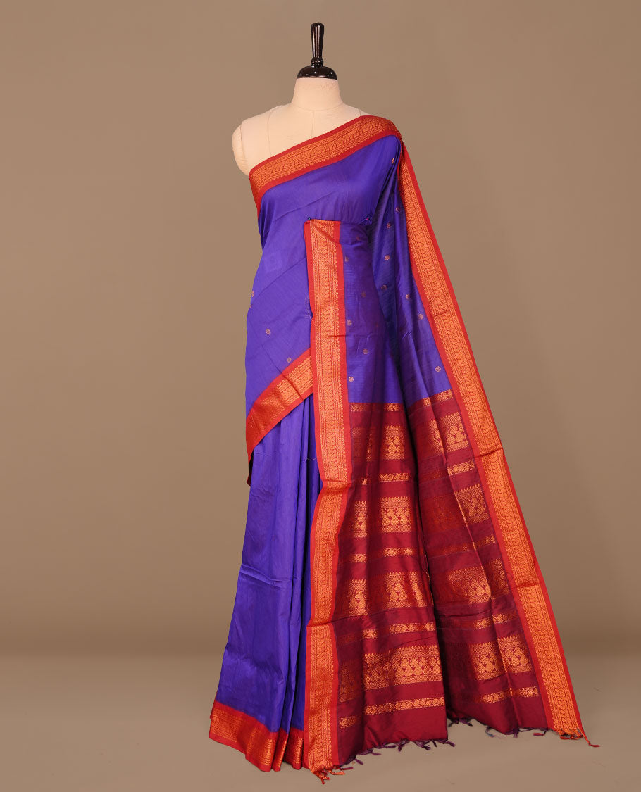 Indigo colour kalyani cotton saree featuring antique zari motifs on body, complemented by Maroon colour with Antique zari border, paired with matching blouse piece.