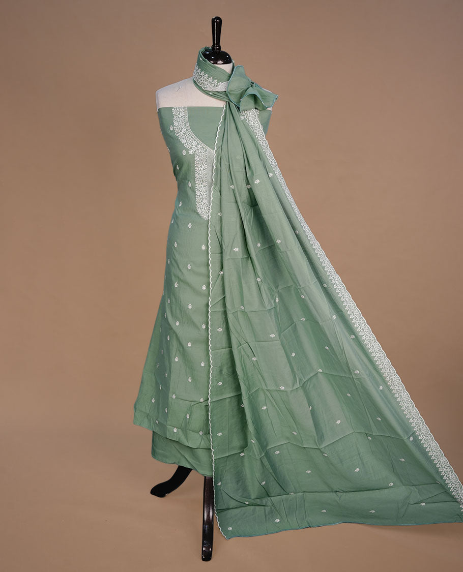 Pastel green colour churidar material feating white thread motifs on body and floral kodi pattern neckline, paired with matching bottom and dupatta.
